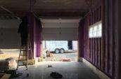 purple spray foam insulation in progress within garage