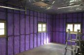 purple spray foam insulation covering walls of garage