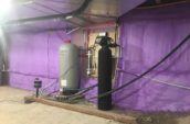 purple spray foam insulation covering walls of basement