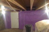 purple spray foam insulation covering walls of basement