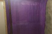 purple spray foam insulation covering wall of basement