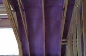 purple spray foam insulation covering roof and walls of home