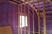 purple spray foam insulation covering walls and roof of house