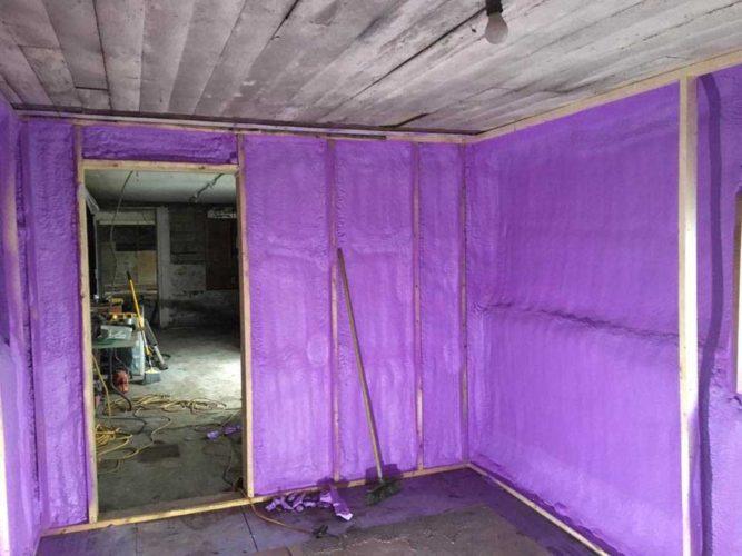 purple spray foam insulation inside framing of office walls