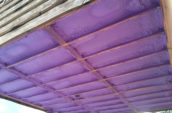 view of purple spray foam insulation for home floor from below