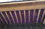view of purple spray foam insulation for home floor from below