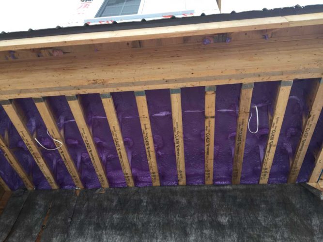 view of purple spray foam insulation for home floor from below
