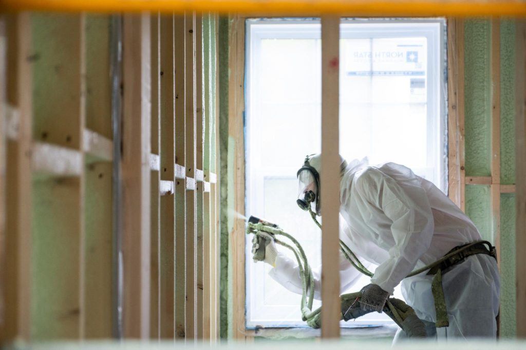 Insulation Contractors applies green sprayfoam in unfinished house